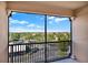 This apartment balcony offers great views of the surrounding neighborhood trees and roads at 8296 Portofino Dr # 401, Davenport, FL 33896