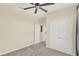 Carpeted bedroom featuring a ceiling fan and a view into the hallway at 8296 Portofino Dr # 401, Davenport, FL 33896