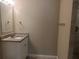 Updated bathroom featuring a granite vanity top and modern fixtures at 905 Governors Ave, Orlando, FL 32808