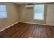 Bright bedroom with hardwood floors, AC, and two windows, filled with natural light at 905 Governors Ave, Orlando, FL 32808