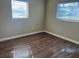 Cozy bedroom with hardwood floors and plenty of natural light from two windows at 905 Governors Ave, Orlando, FL 32808