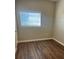 Clean bedroom features laminate wood flooring and a window, creating a calming space at 905 Governors Ave, Orlando, FL 32808