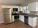 Well-equipped kitchen with stainless steel appliances and sleek white cabinetry at 905 Governors Ave, Orlando, FL 32808