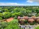 Aerial view of complex with lush greenery, palm trees, and parking at 976 E Michigan St # A, Orlando, FL 32806
