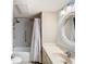 Well-lit bathroom featuring white cabinets and shower with curtain at 976 E Michigan St # A, Orlando, FL 32806