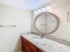 Granite countertops and a decorative mirror enhance this well-lit bathroom at 976 E Michigan St # A, Orlando, FL 32806
