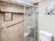Tiled bathroom features an enclosed shower with safety bar and unique inset shelf at 976 E Michigan St # A, Orlando, FL 32806