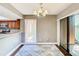 Dining area with modern chandelier and sliding glass doors to private patio at 976 E Michigan St # A, Orlando, FL 32806