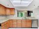 Charming kitchen boasts wood cabinetry, granite countertops, and stainless steel appliances at 976 E Michigan St # A, Orlando, FL 32806