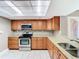 Well-lit kitchen features stainless steel appliances, granite countertops, and ample cabinet space at 976 E Michigan St # A, Orlando, FL 32806