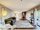Spacious living room featuring a stone fireplace and ample natural light at 976 E Michigan St # A, Orlando, FL 32806