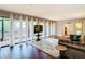 Bright living room with stone fireplace and access to outdoor patio through glass doors at 976 E Michigan St # A, Orlando, FL 32806