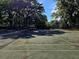 Outdoor tennis court, surrounded by mature trees, providing residents with recreational opportunities at 976 E Michigan St # A, Orlando, FL 32806