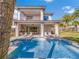 Modern backyard with a sparkling pool, outdoor kitchen and patio furniture at 985 Jack Nicklaus Ct, Kissimmee, FL 34747