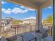 Balcony with table and chairs offering neighborhood views, blue skies and puffy white clouds at 985 Jack Nicklaus Ct, Kissimmee, FL 34747