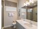 Bathroom features a modern vanity, decorative mirror, and glass enclosed shower at 985 Jack Nicklaus Ct, Kissimmee, FL 34747
