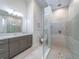 Modern bathroom with a glass-enclosed shower, granite countertop vanity, and sleek fixtures at 985 Jack Nicklaus Ct, Kissimmee, FL 34747