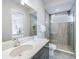 Modern bathroom featuring a glass shower, vanity, and open doorway to the bedroom at 985 Jack Nicklaus Ct, Kissimmee, FL 34747