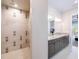 Modern bathroom featuring a glass shower with dual vanity sinks and granite countertop at 985 Jack Nicklaus Ct, Kissimmee, FL 34747