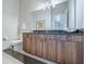 Bathroom featuring modern vanity with dark wood cabinets, large mirror, and decorative mosaic tile accents at 985 Jack Nicklaus Ct, Kissimmee, FL 34747