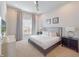 Cozy bedroom featuring a large window, soft carpeting, neutral tones, and comfortable furnishings at 985 Jack Nicklaus Ct, Kissimmee, FL 34747