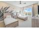 Bedroom with two twin beds, graphic accent wall, and large window at 985 Jack Nicklaus Ct, Kissimmee, FL 34747