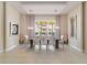 Dining room features a modern light fixture and window with views of the landscaping at 985 Jack Nicklaus Ct, Kissimmee, FL 34747