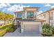 Lovely two-story home boasting a balcony, front lawn, and two-car garage at 985 Jack Nicklaus Ct, Kissimmee, FL 34747