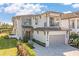 Beautiful two-story home featuring a stone facade, balcony, well-manicured lawn and two-car garage at 985 Jack Nicklaus Ct, Kissimmee, FL 34747