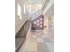 Spacious two-story foyer featuring a staircase with modern railings, high ceilings and stylish decor at 985 Jack Nicklaus Ct, Kissimmee, FL 34747