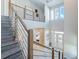 Grand two-story foyer with staircase, modern railings, and natural light at 985 Jack Nicklaus Ct, Kissimmee, FL 34747