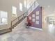 Grand two-story foyer with staircase, modern railings, high ceilings, and stylish decor at 985 Jack Nicklaus Ct, Kissimmee, FL 34747