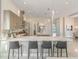 Modern kitchen with long center island, sleek cabinetry, and pendant lighting at 985 Jack Nicklaus Ct, Kissimmee, FL 34747
