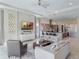 Open-concept living space featuring modern sofas, a sleek TV console, and view of the kitchen at 985 Jack Nicklaus Ct, Kissimmee, FL 34747