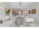 Bright living room open to kitchen with modern furnishings and a large TV at 985 Jack Nicklaus Ct, Kissimmee, FL 34747
