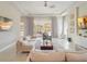 Bright living room boasts neutral decor, tile floors, and sliders to the outdoor living area at 985 Jack Nicklaus Ct, Kissimmee, FL 34747