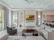 Bright living room with tile floors, modern decor, and direct access to the outdoor area at 985 Jack Nicklaus Ct, Kissimmee, FL 34747