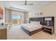 Stately main bedroom featuring tray ceiling, access to balcony and calm, neutral colors at 985 Jack Nicklaus Ct, Kissimmee, FL 34747