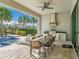 Outdoor kitchen with a grill, and bar seating, next to the pool with ample seating area at 985 Jack Nicklaus Ct, Kissimmee, FL 34747