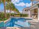 Stunning private backyard pool and spa area with built-in grill and outdoor seating at 985 Jack Nicklaus Ct, Kissimmee, FL 34747