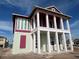 A two-story home under construction shows its framing, which includes white columns and light green and maroon trim at 10025 Dulbecco St, Orlando, FL 32827