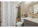 Modern bathroom featuring a tiled shower with rainfall head, and a vanity with a gray cabinet at 1004 Sunwood Lane Ln, Orlando, FL 32807