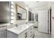 Bathroom with double vanity, marble countertop, and a large mirror with vanity lights at 1004 Sunwood Lane Ln, Orlando, FL 32807