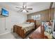 Comfortable bedroom featuring a ceiling fan, window, and a warm color scheme at 1004 Sunwood Lane Ln, Orlando, FL 32807