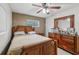 Bedroom featuring a wooden bed frame, neutral tones, and natural light from a window at 1004 Sunwood Lane Ln, Orlando, FL 32807