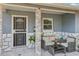 Inviting covered porch with stone accents, outdoor seating, and decorative tile flooring at 1004 Sunwood Lane Ln, Orlando, FL 32807