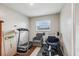 Home gym equipped with a treadmill, weights, chair, and natural light at 1004 Sunwood Lane Ln, Orlando, FL 32807