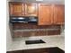 Close up of dark wood cabinets, laminate countertops, and a modern glass cooktop at 1004 Sunwood Lane Ln, Orlando, FL 32807