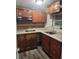 Kitchen with dark wood cabinets, laminate countertops, and a modern glass cooktop at 1004 Sunwood Lane Ln, Orlando, FL 32807