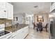 Open-concept kitchen with stainless steel appliances and granite countertops, adjacent to the dining area at 1004 Sunwood Lane Ln, Orlando, FL 32807